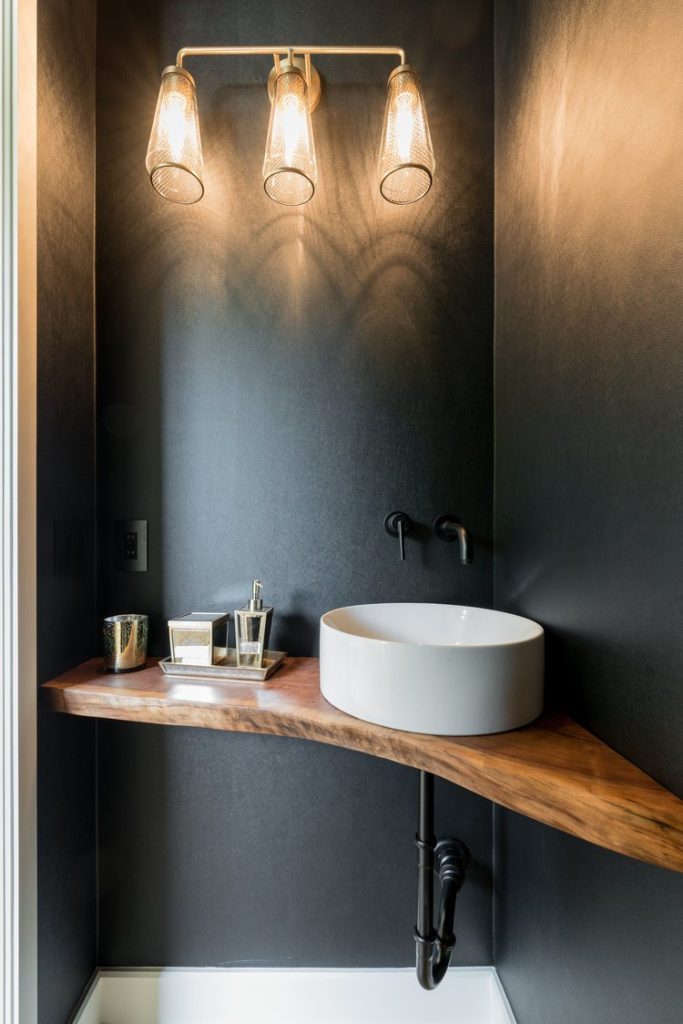 Minimalist Louisville bathroom by luxury custom home builders with wooden countertop, round basin, and black taps.