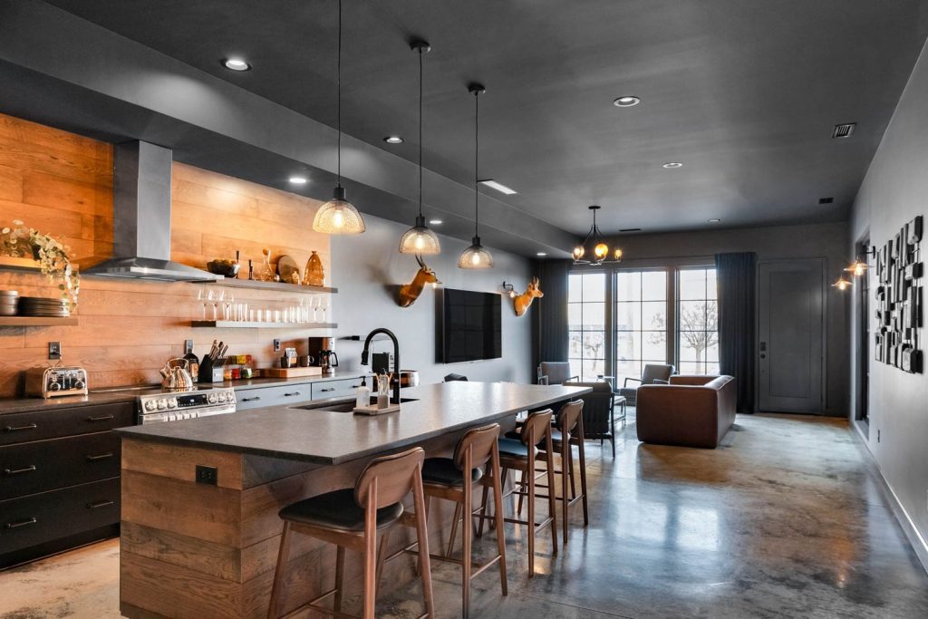 Louisville modern farmhouse kitchen with large island, wooden stools, pendant lights, and cozy window seating.