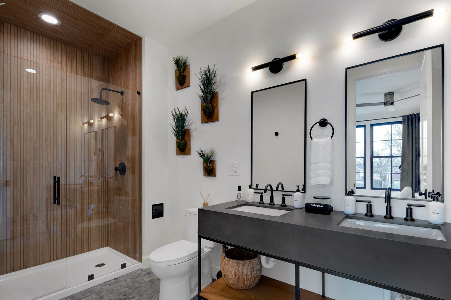 Optimized Alt Text: Louisville modern Japandi bathroom with glass shower, dual black sinks, wall plants, and soft ambient lighting. Character Count (Alt Text): 123 Image Title: Serene Louisville Modern Japandi Bathroom with Glass Shower, Dual Black Sinks, Wall Plants, and Soft Lighting