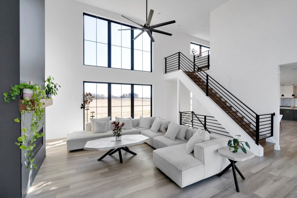 Bright and Airy Louisville Modern Living Room with Sleek Fireplace Designed by Leading Custom Home Builders