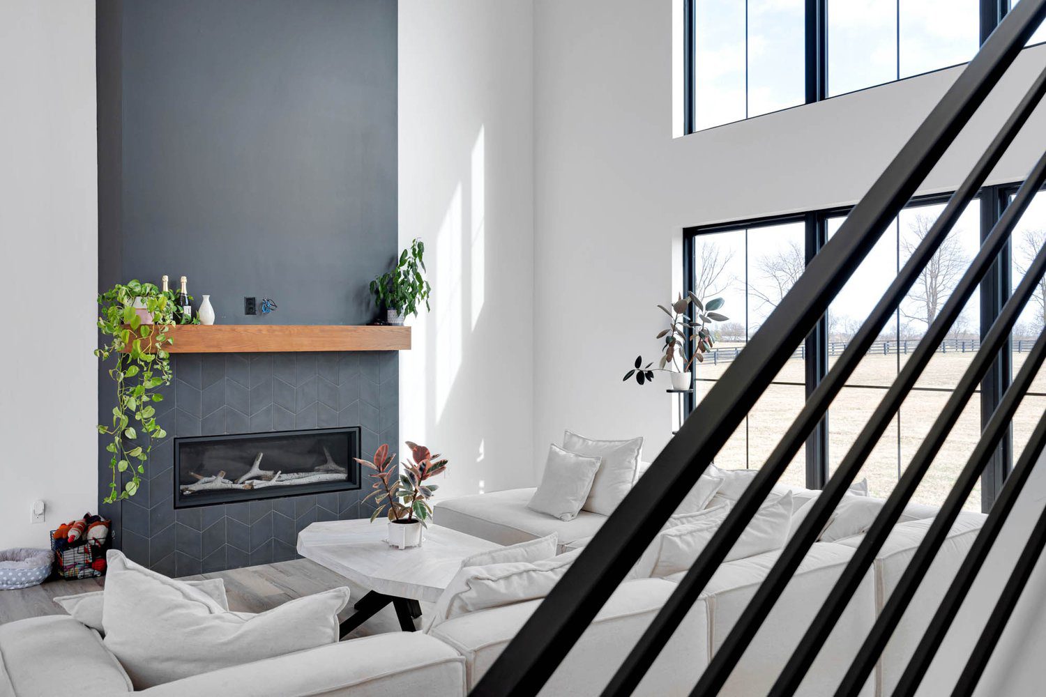 Bright Louisville Modern Living Room with Gray Fireplace and Minimalist Design by Leading Home Builders