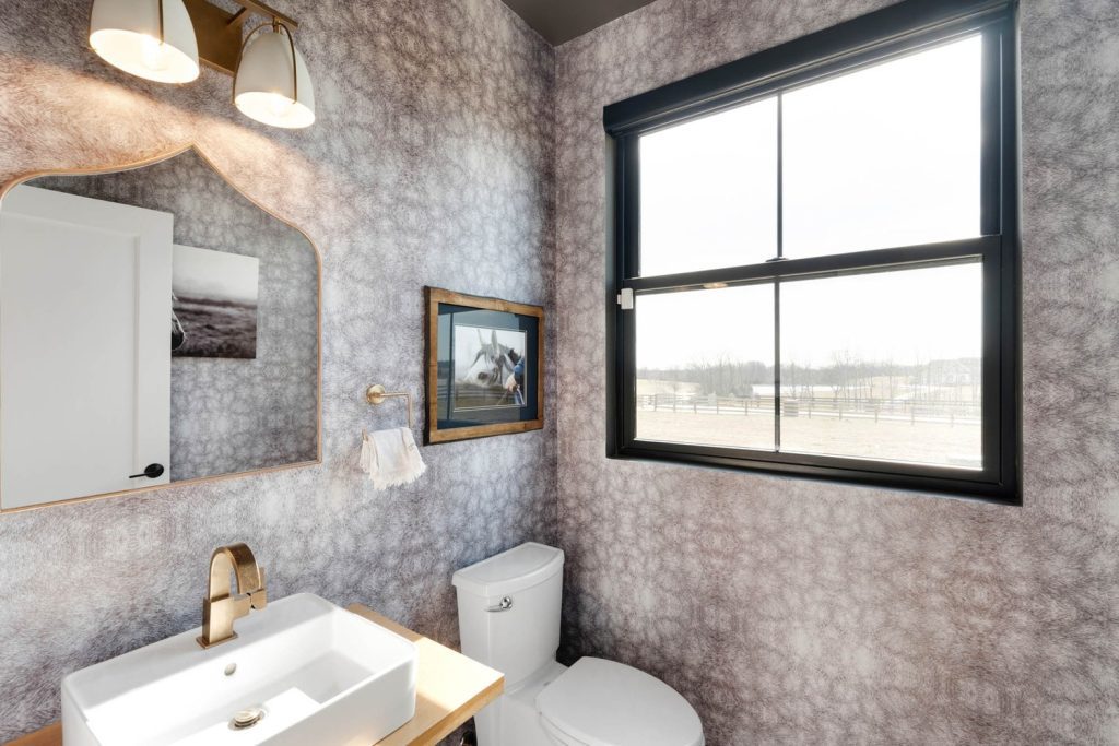 Louisville small bathroom with patterned wallpaper, white vanity, scenic window, and calm modern farmhouse style.