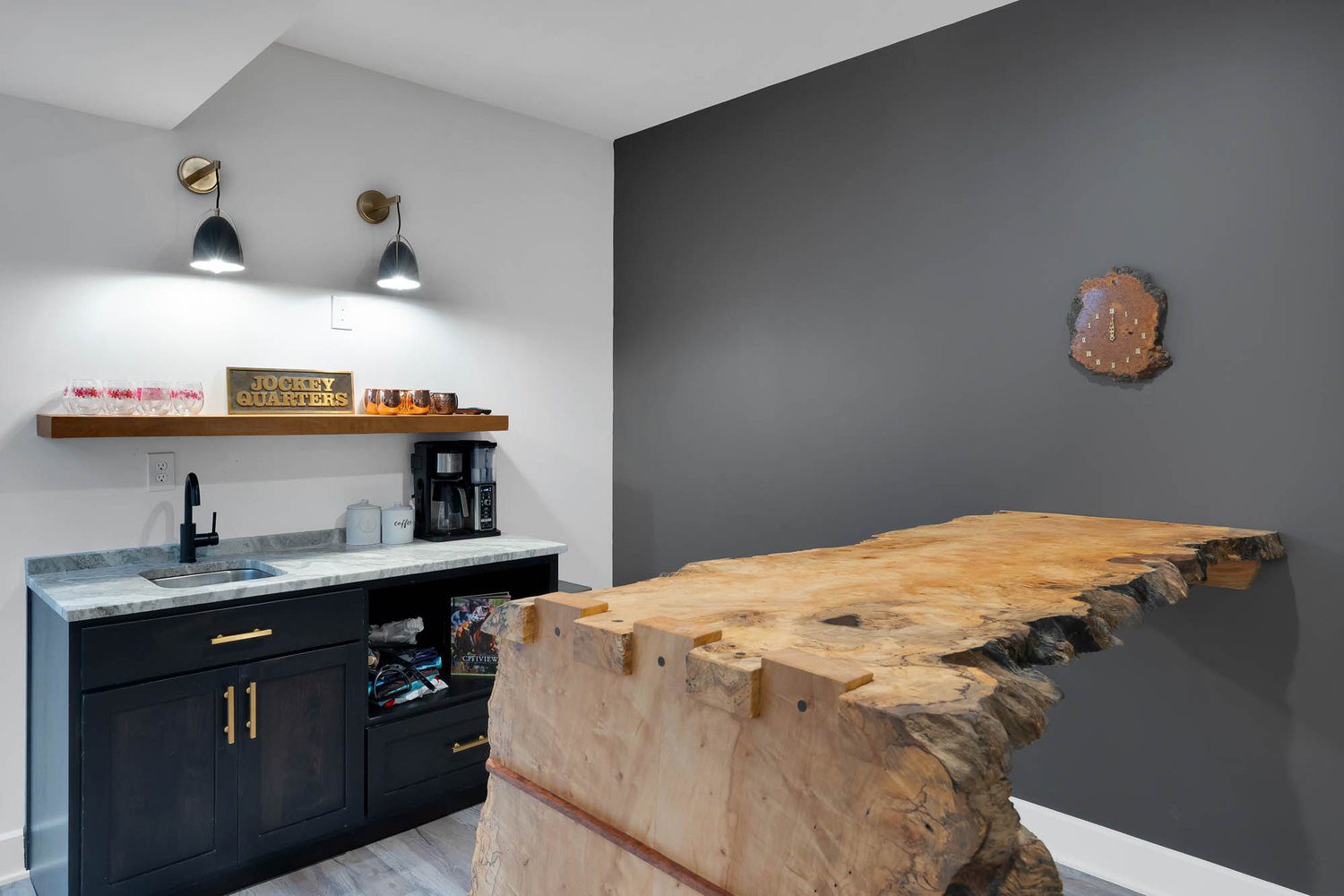 Louisville modern kitchen with live-edge wooden counter, dark cabinets, and cozy rustic design by top home builders.