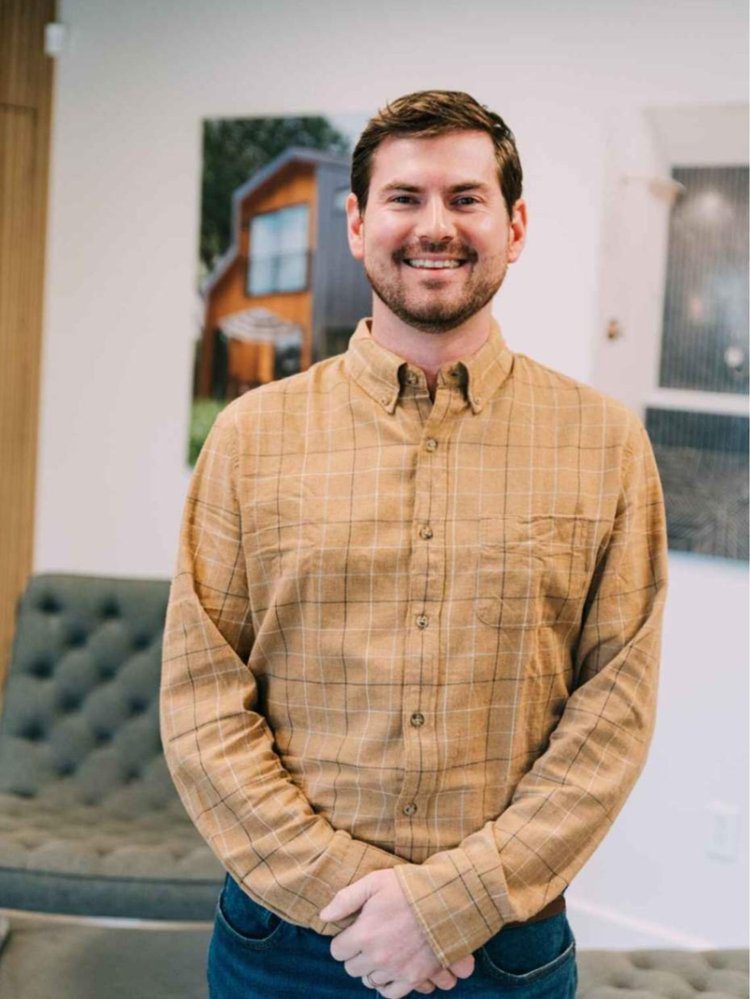 Matt Eldridge, Louisville Signature Home Director of Operations, smiling in a cozy office setting.