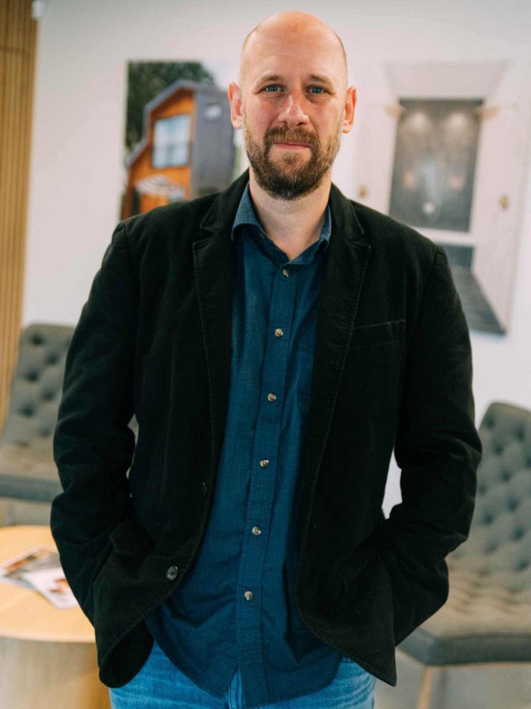 Scott Huff, Louisville senior architectural designer, standing confidently in a modern office.