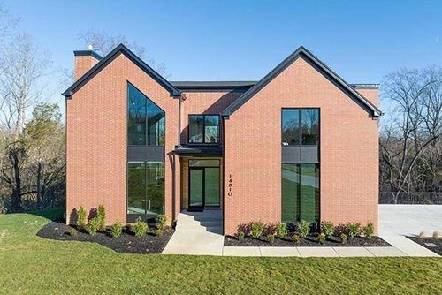 Elegant two-story brick home in Louisville by a top custom home builder, featuring modern design and craftsmanship.
