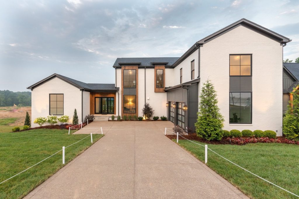 Modern white two-story luxury custom home in Louisville built by top-rated Eldridge Company, showcasing sleek design.