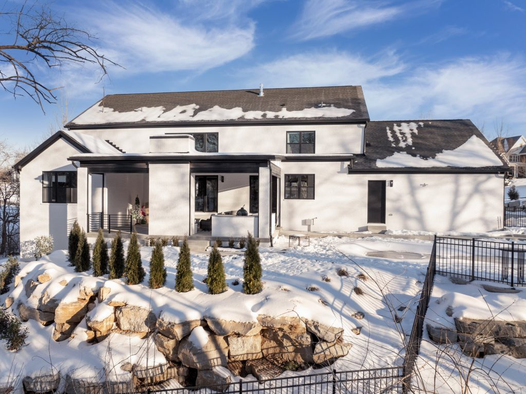 home with sloped roof and snowy landscape by top custom home builders Eldridge Company.