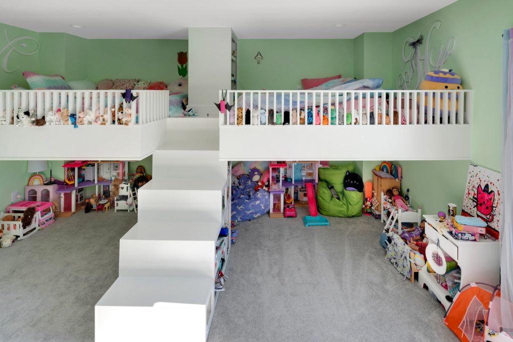 Luxury children’s bedroom design ideas with loft beds and colorful, organized play area Louisville, KY.