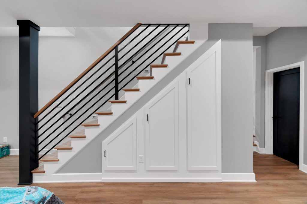 Louisville custom home design ideas staircase with hidden storage, wood treads, and black railing by top modern home builders.