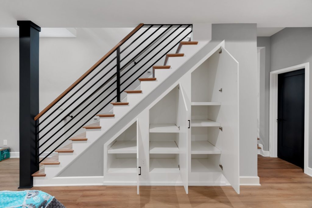 Louisville custom storage under stairs with open shelving and drawers by top modern home builders creating smart new home design ideas.
