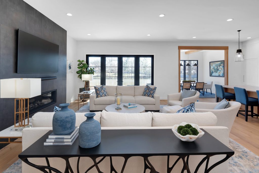 Louisville modern living room with neutral tones, beige sofas, and open layout by top custom home builders Eldridge Company.