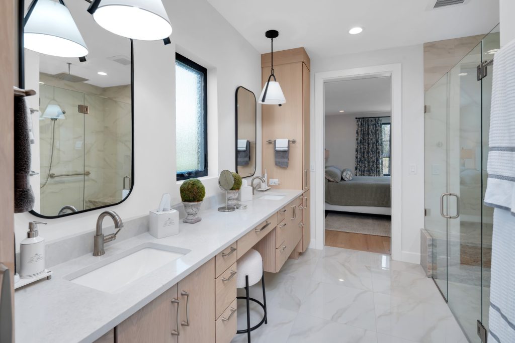 Louisville modern bathroom by top custom home builders with dual sinks, marble floor, and elegant lighting.