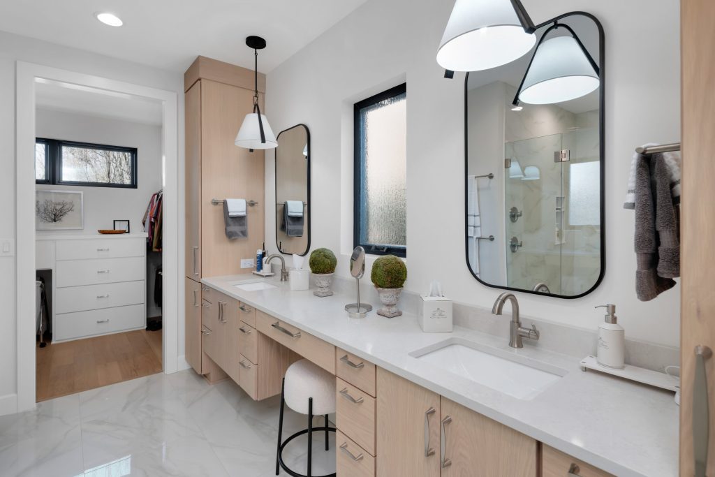 Louisville elegant bathroom by top custom home builders with dual sinks, large mirrors, and serene decor.