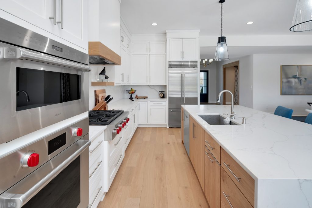 Louisville modern kitchen with white cabinets, stainless appliances, and wood accents by Eldridge Company.