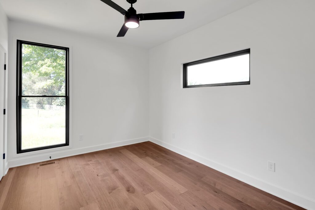 Contemporary Louisville room with minimal design, wood floors, and fresh natural light.