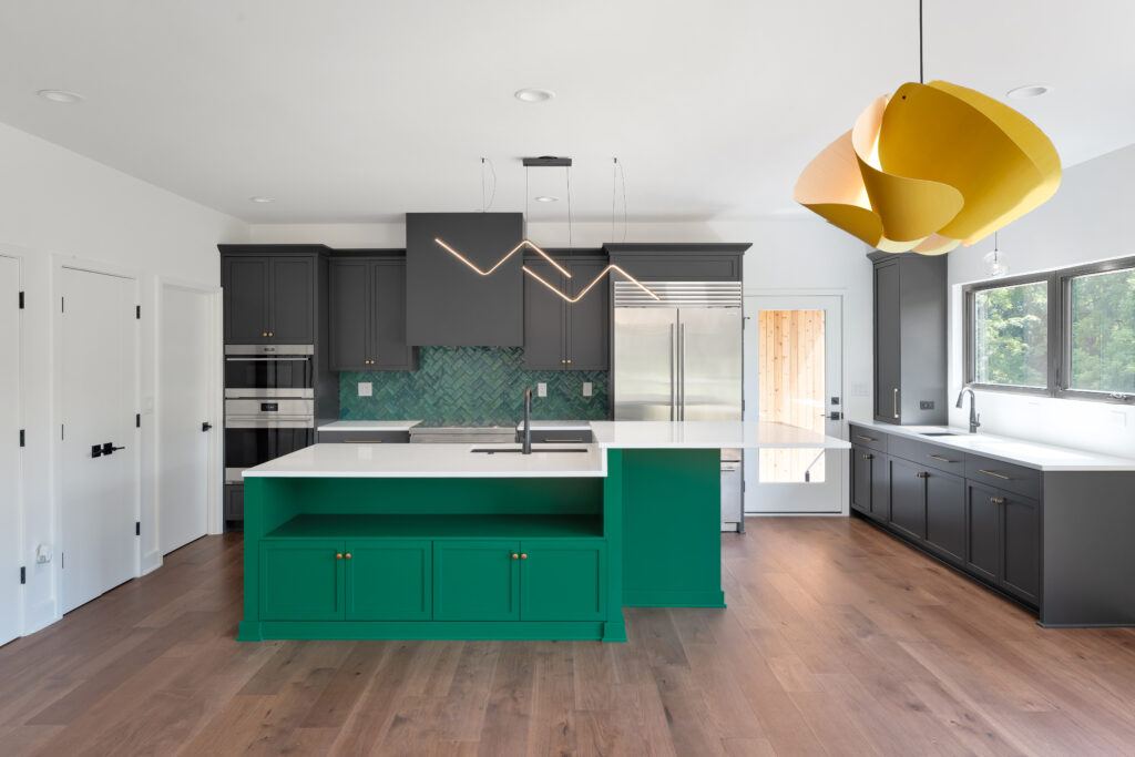 Custom Louisville kitchen design with dark cabinets, herringbone backsplash, and green island.