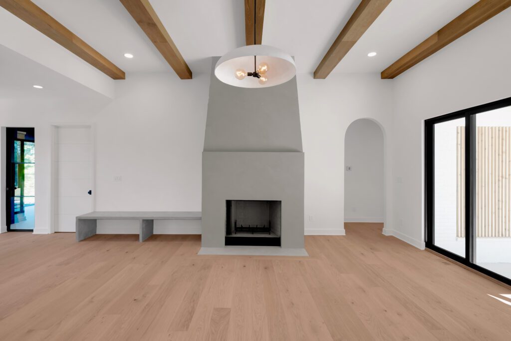 Louisville modern interior with central fireplace, exposed wooden beams, and bright ambiance.