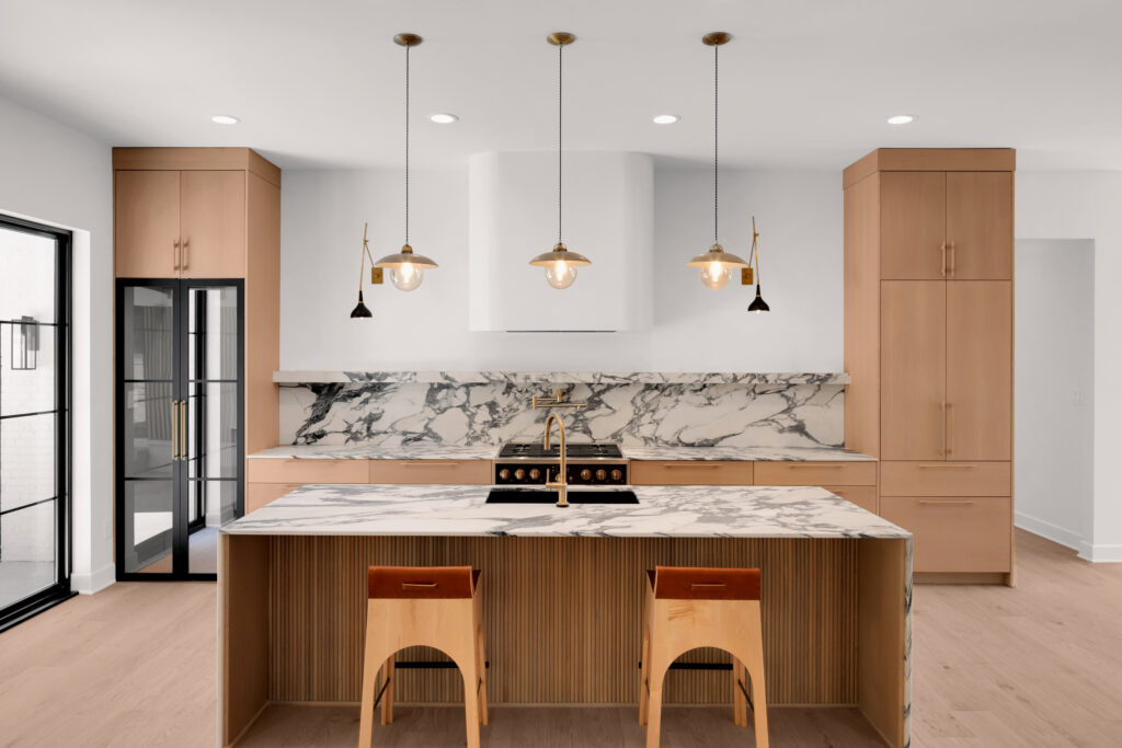 Modern Louisville kitchen with Sub-Zero fridge, Wolf appliances, and marble countertops.