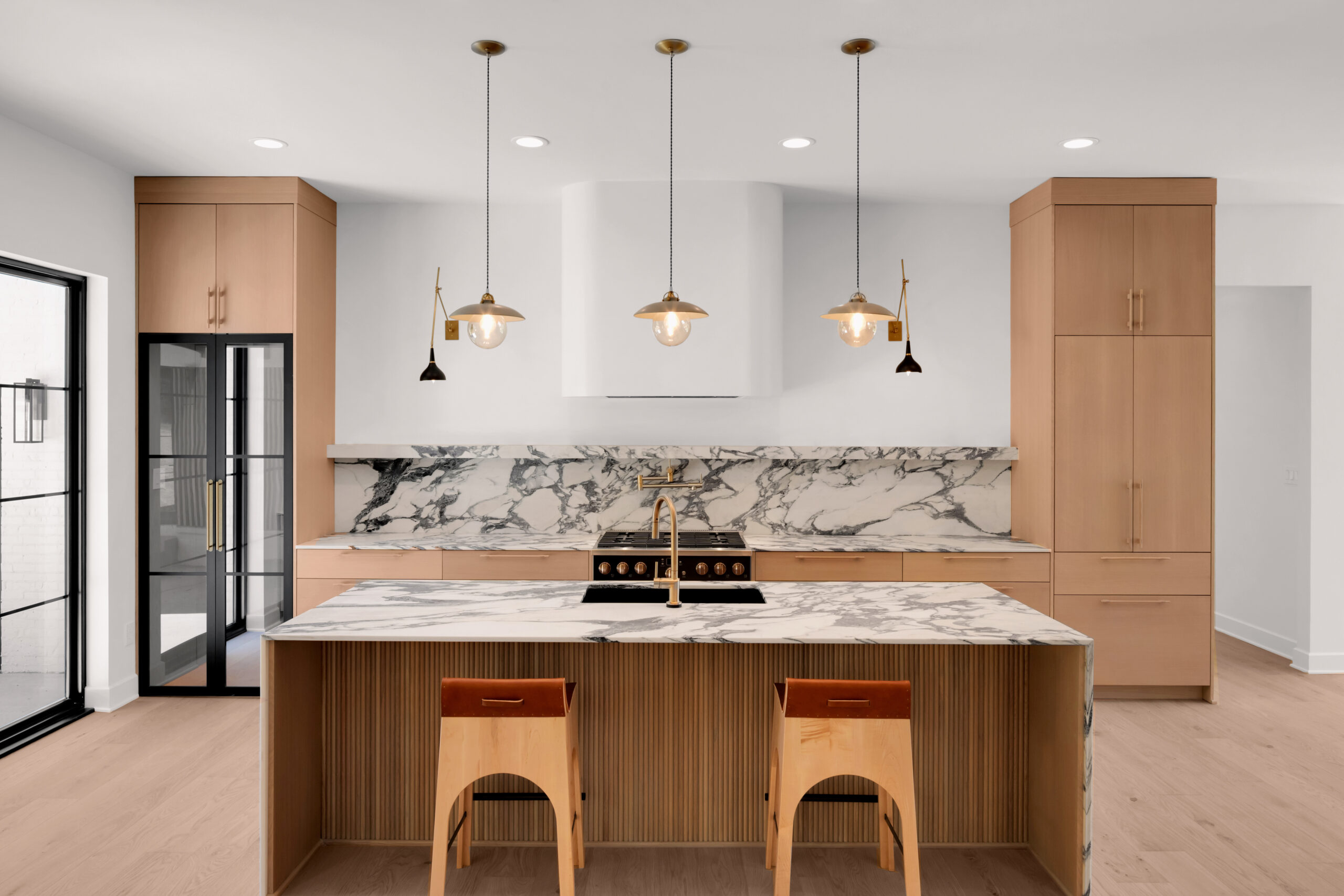 Modern Louisville kitchen with Sub-Zero fridge, Wolf appliances, and marble countertops.