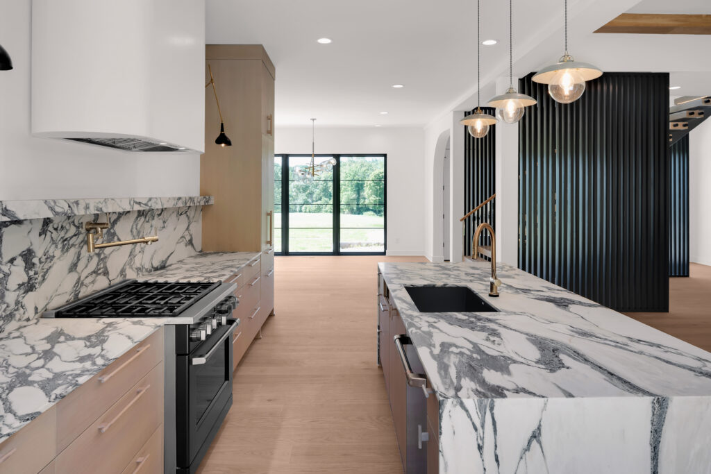 Louisville luxury kitchen with Sub-Zero refrigerator, Wolf ovens, and light wood cabinets.