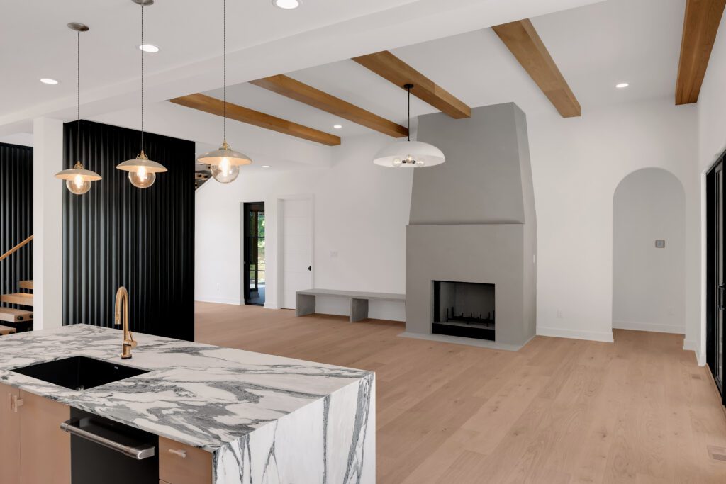 Louisville luxury interior with kitchen island, fireplace, and minimalist design accents.