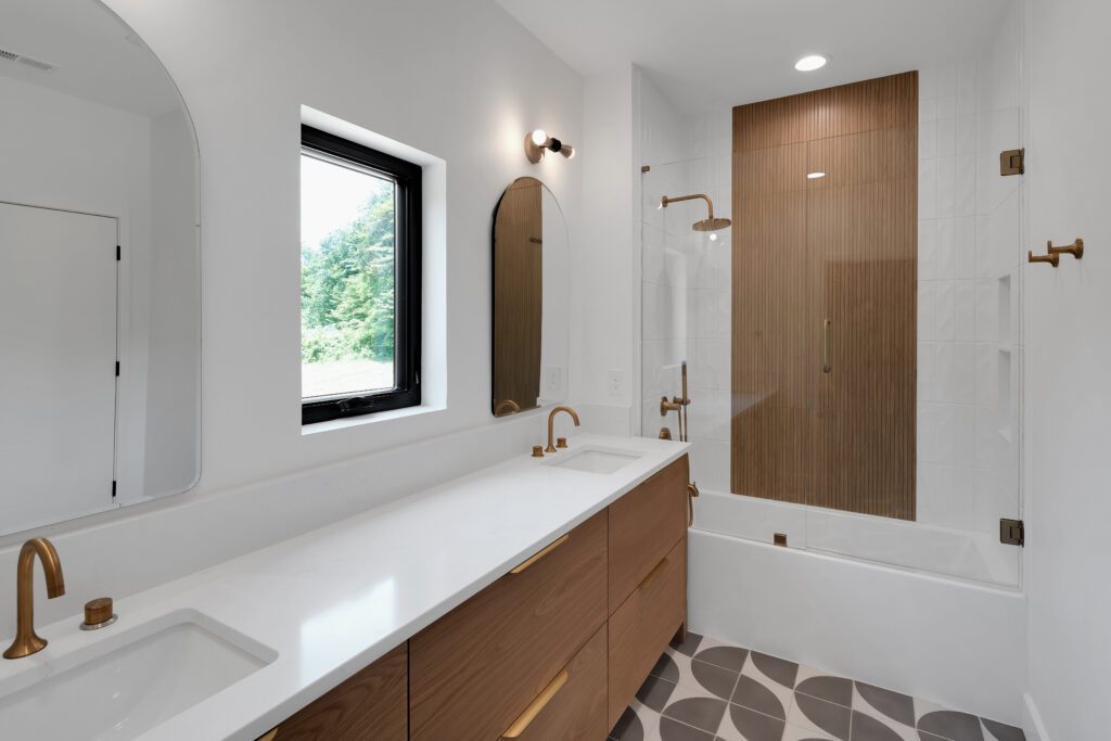 Minimalist Louisville bathroom with wood vanity, gold accents, and stylish tile flooring