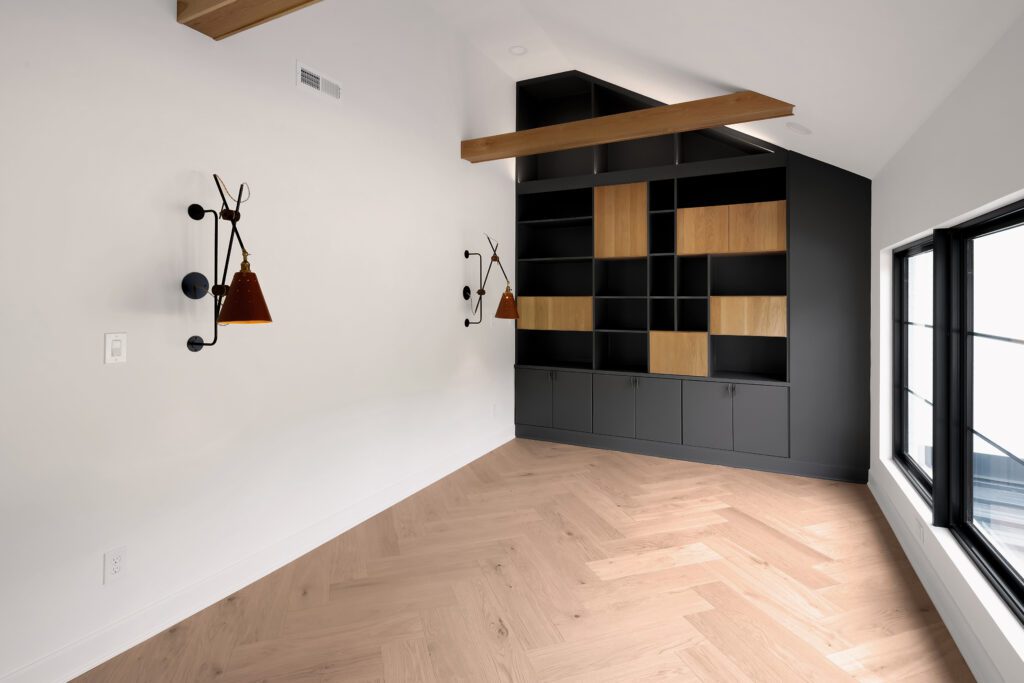 Contemporary Louisville room with black and wood accents, wall sconces, and hardwood floor.