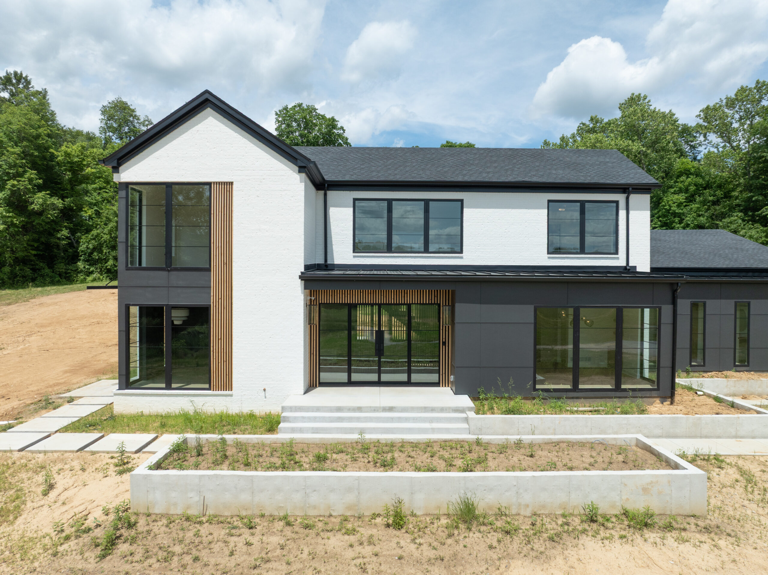 Sleek Louisville custom home with large windows and minimalist black and white exterior.