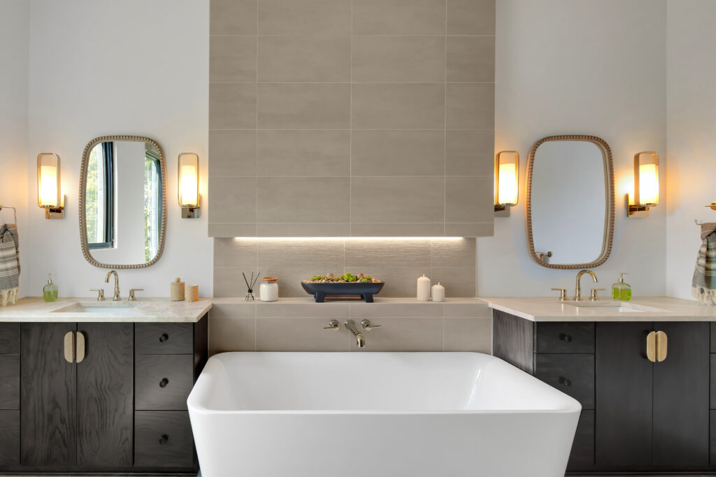 Louisville modern bathroom with freestanding tub, dual sinks, and elegant lighting by top custom home builders.
