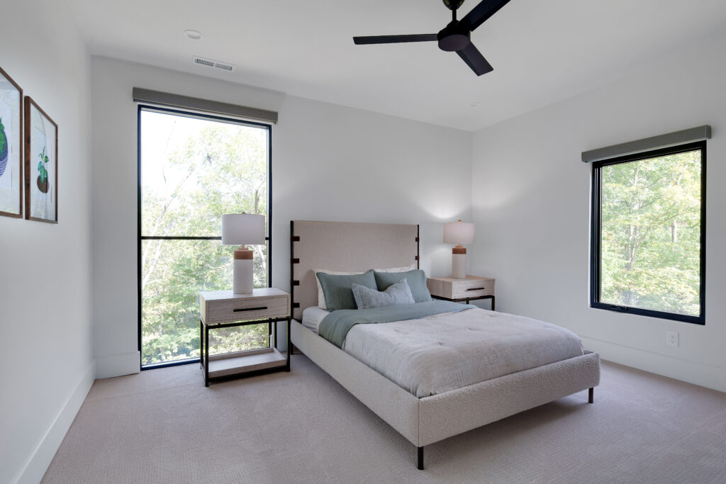 Louisville modern bedroom with large bed and neutral tones by top custom home builders, Eldridge Company.