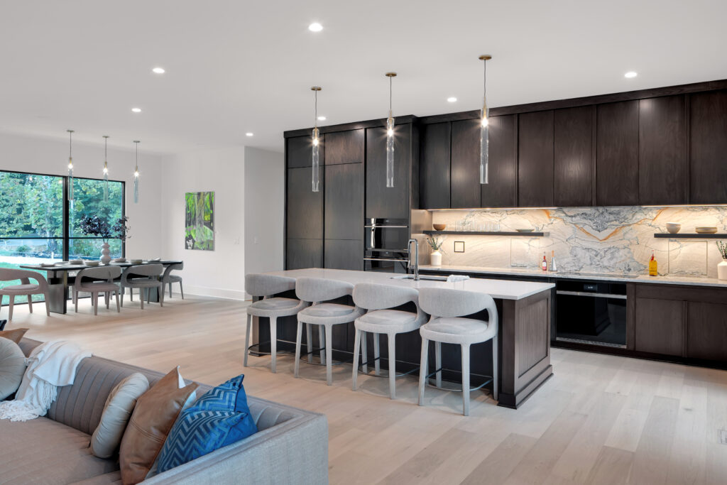 Louisville modern kitchen with dark cabinets, marble backsplash, and island by top custom home builders Eldridge Company.