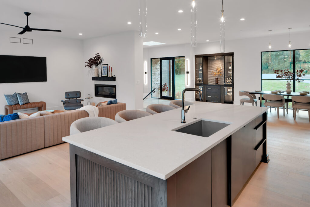 Modern Louisville open-concept living with kitchen island and lounge by top custom home builders.