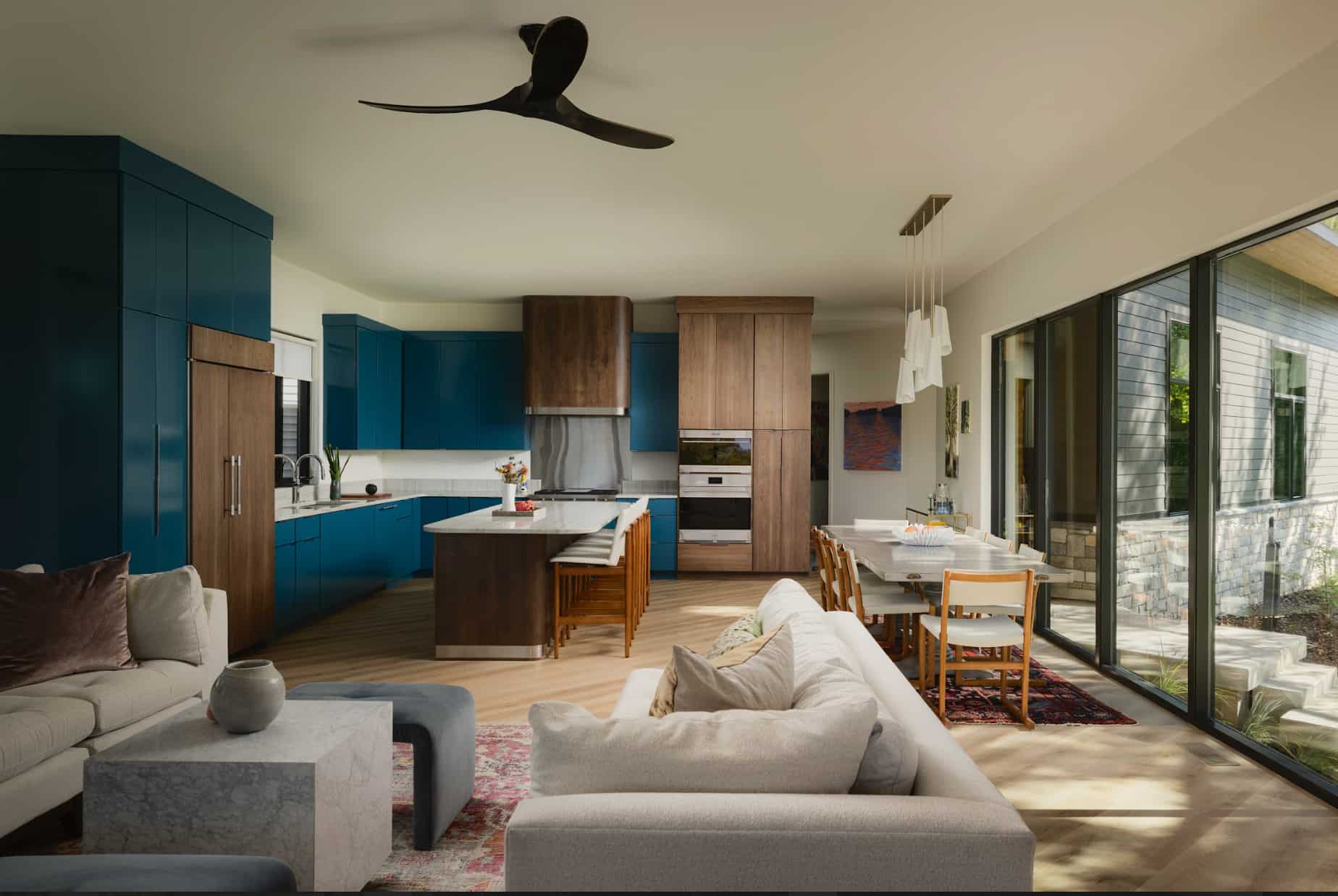 Custom built blue cabinetry in a kitchen with sub zero wolf products.