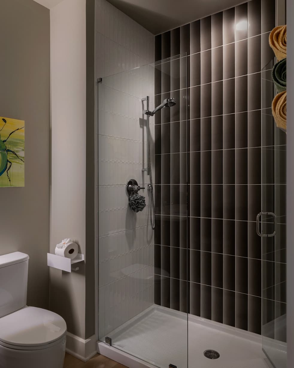 Dark and moody custom tiled bathroom shower in custom home by Eldridge Company.