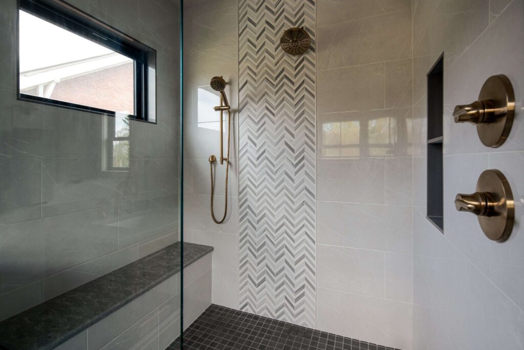Renovated shower room with gold plumbing fixtures